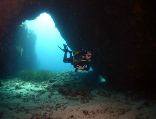 Blue Island Divers gallery 1 - Scuba diver diving inside a cavern in Antiparos